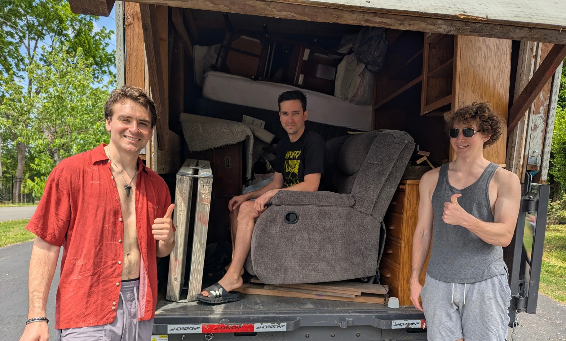 The Hauling Patriots crew posing at the back of a loaded trailer on moving day